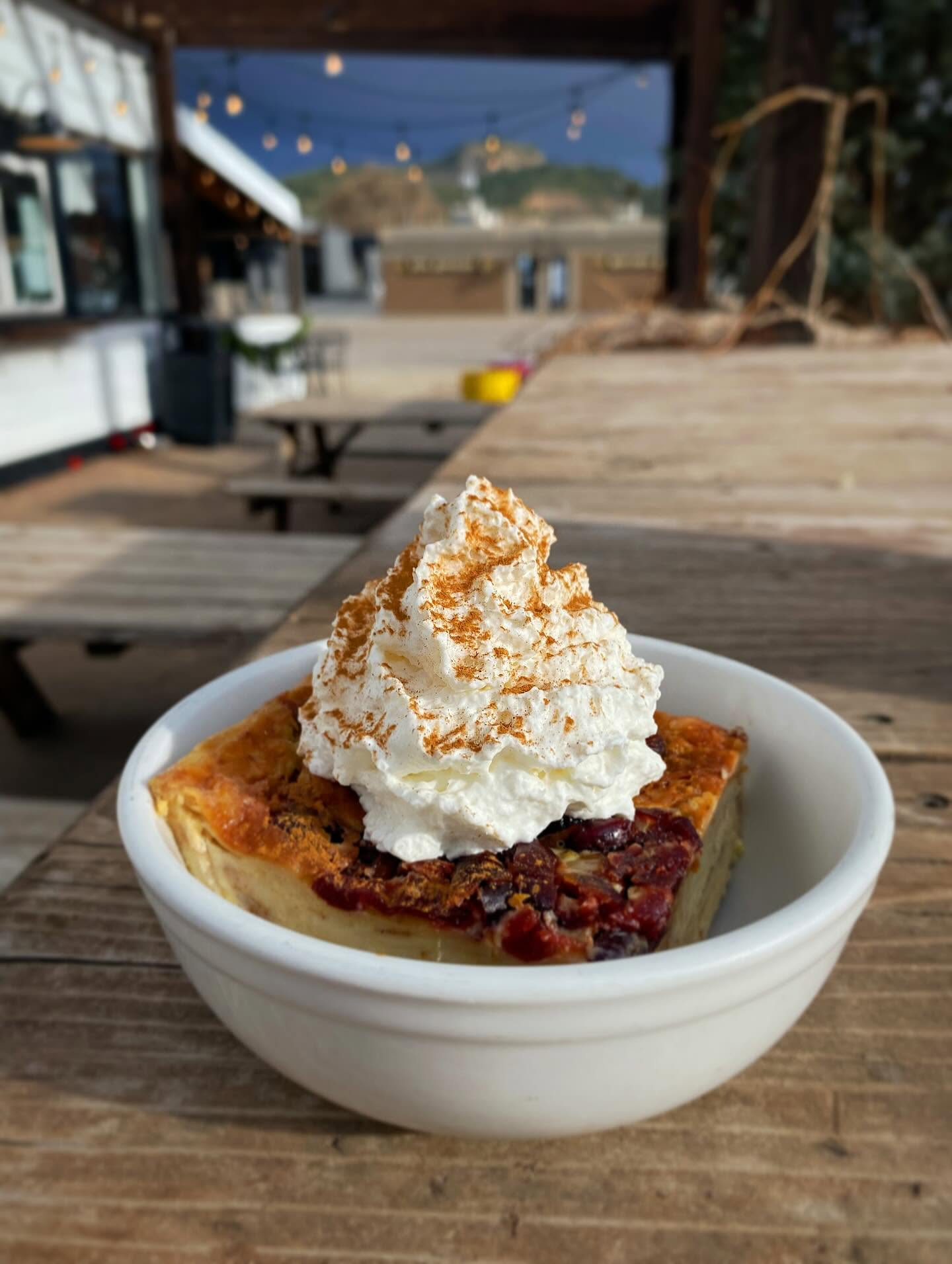 Cranberry bread pudding topped with cinnamon whipped cream