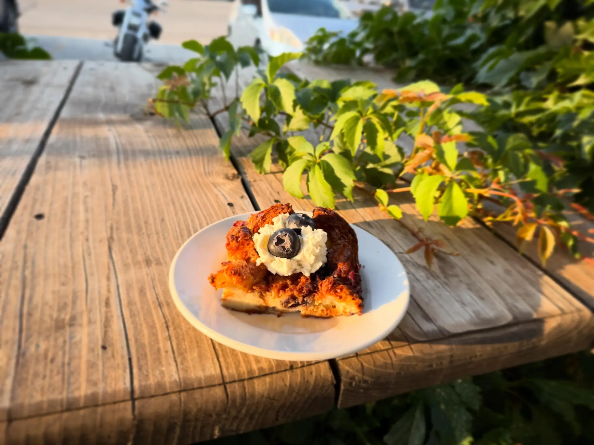 Blueberry bread pudding with whipped cream on the patio table