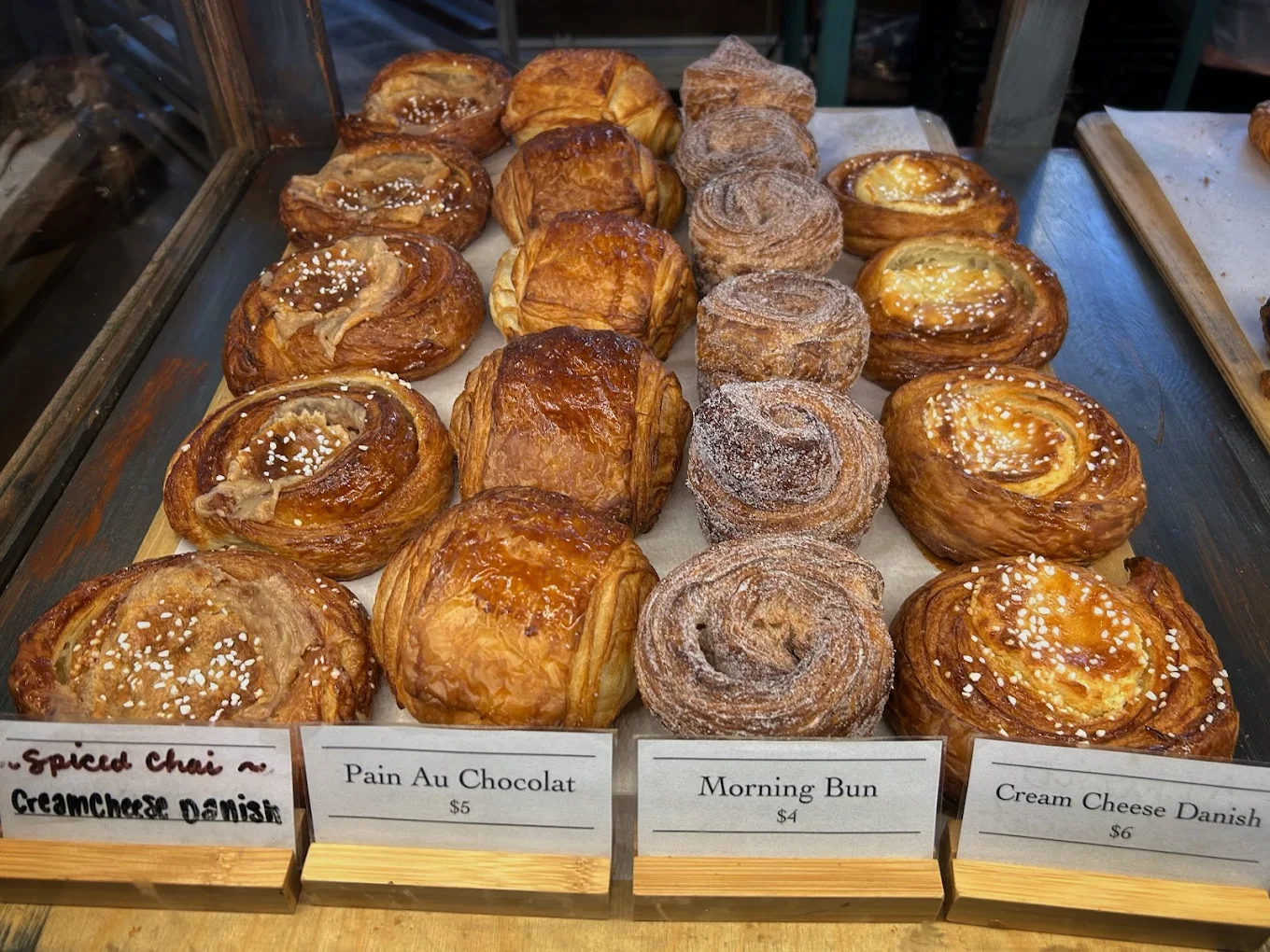 Croissants, morning buns, and danishes in the pastry case