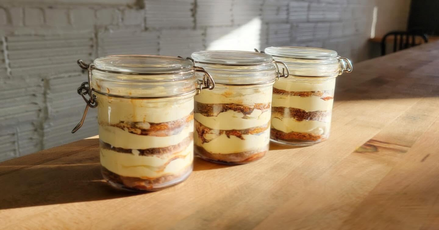 Tiramisu jars lined up on the counter in the morning sun